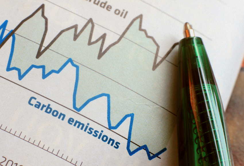 A page that shows carbon emission statistics next to a pen. 
